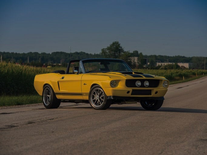 Yellow classic Mustang parked outside